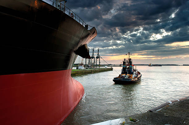 Tug boat Tug boat taking out the ship from the harbor barge stock pictures, royalty-free photos & images