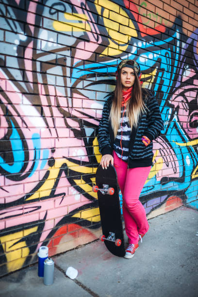 istock Urban young woman with skateboard 1245729385