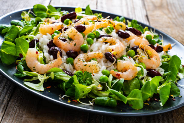 istock Prawns with vegetables on wooden table 1245746453