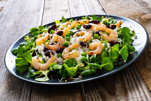 istock Prawns with vegetables on wooden table 1245746992