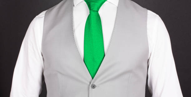 istock Man in a grey suit with green tie, close-up 1245747540