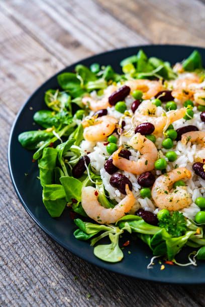 istock Prawns with vegetables on wooden table 1245748140