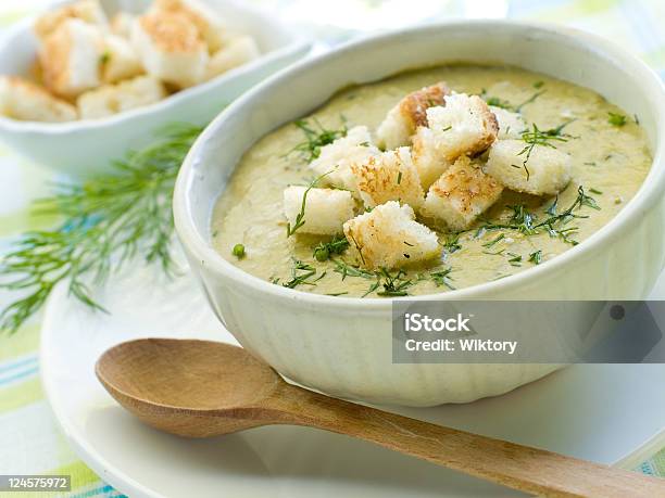 White Bowl Of Soup With Croutons Next To A Wooden Spoon Stock Photo - Download Image Now