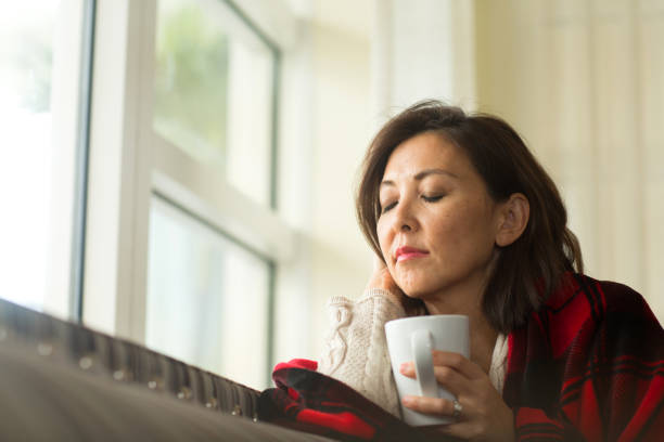 istock Mature woman feeling sad looking out a window. 1245785325
