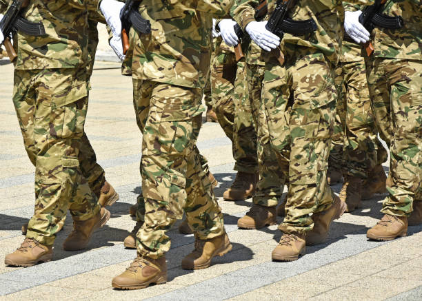 istock Soldiers marching with machine guns in hand 1245790510