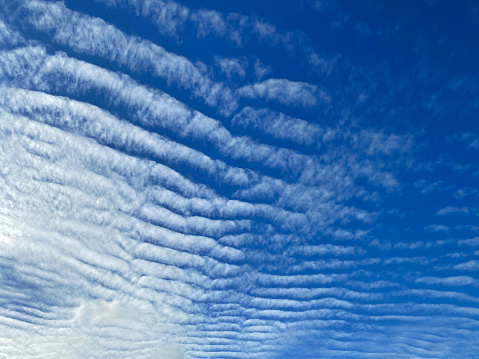 Blue sky with altocumulus clouds.