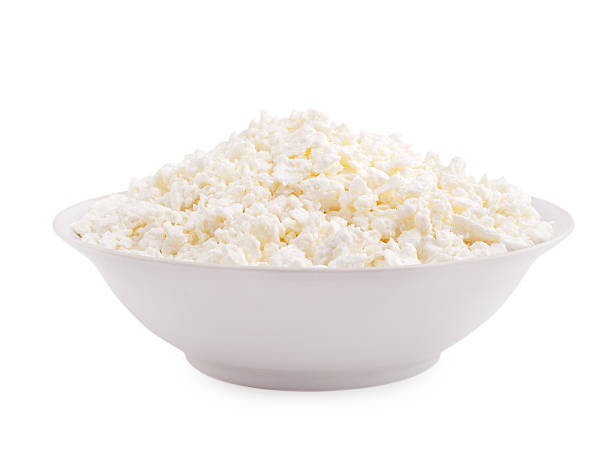 istock Cottage cheese in plate isolated on white background 124581151