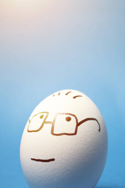 istock Drawing of Optimistic Facial Expression on an Egg with Blue Background. 1245822859