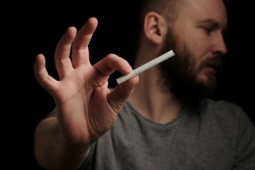 Hands bearded man with cigarette, close up. Give up smoking cigarettes. Man with bad harmful for his health habit. Do not choose wrong lifestyle. Quit smoking addiction concept. Stop smoking message