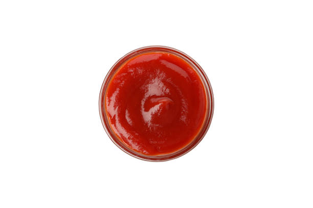 istock Glass bowl with tomato sauce isolated on white background 1245848417