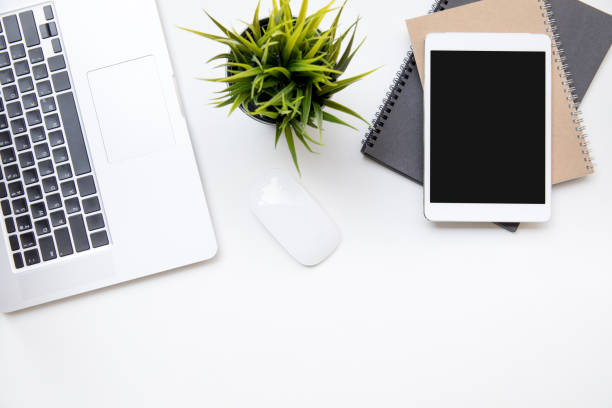 istock office desk table work space top overhead place layout left laptop keyboard center plant with mouse for use right laptop isolated on notebook 1245852142