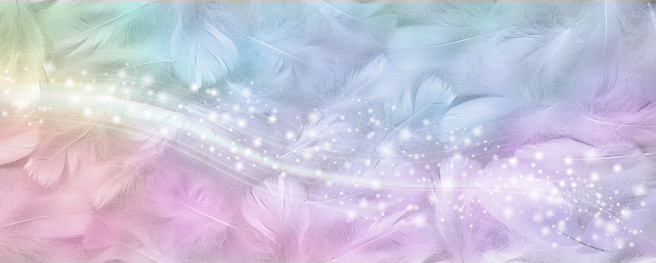 wide background with random scattered small white bird feathers coloured with rainbow hues and a band of sparkles cascading across