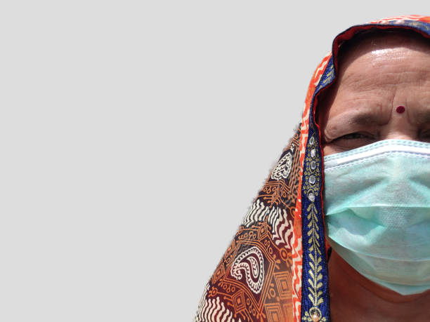 istock Village Woman in face mask on plain background 1245870741