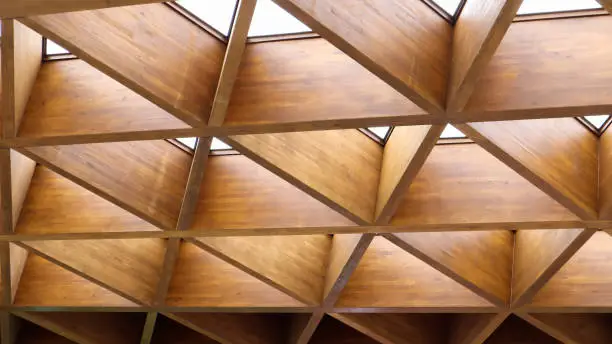 Photo of Luxurious geometric wooden triangles in construction. The concept of modern architecture, design and interior. Wood background. Modular canopy or roof