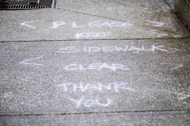 istock COVID-19 Message in Chalk, Please Keep Sidewalk Clear Thank You 1245876122