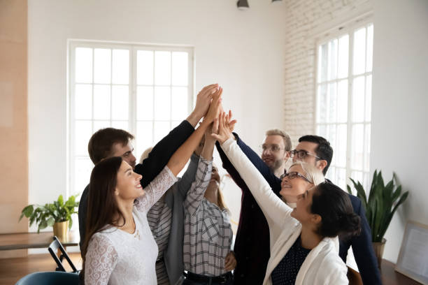 istock Overjoyed diverse teammates giving high five to each other. 1245876127
