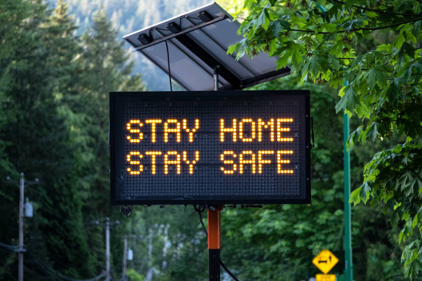 Solar Powered Stay Home Stay Safe Road Sign Covid-19 sign, North Vancouver, British Columbia, Canada stay at home order stock pictures, royalty-free photos & images