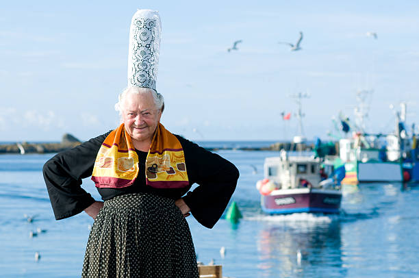 breton women with headdress breton women with headdress posing on a harbor in brittany with fisher boat headdress stock pictures, royalty-free photos & images