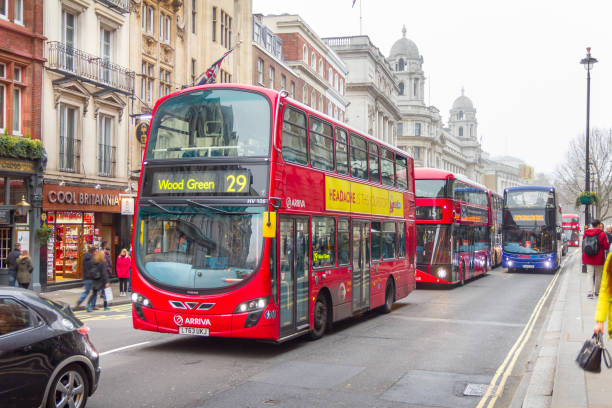 Modern red double decker bus in the center of the city, London, England London, England - December 18, 2016: Modern red double decker bus in the center of the city. Double-decker buses are in common use throughout the United Kingdom. boris bus stock pictures, royalty-free photos & images