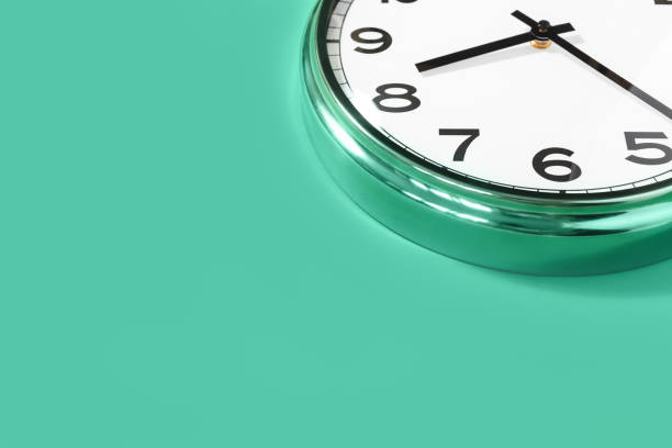 istock Part of wall clock on pastel mint background 1245883177