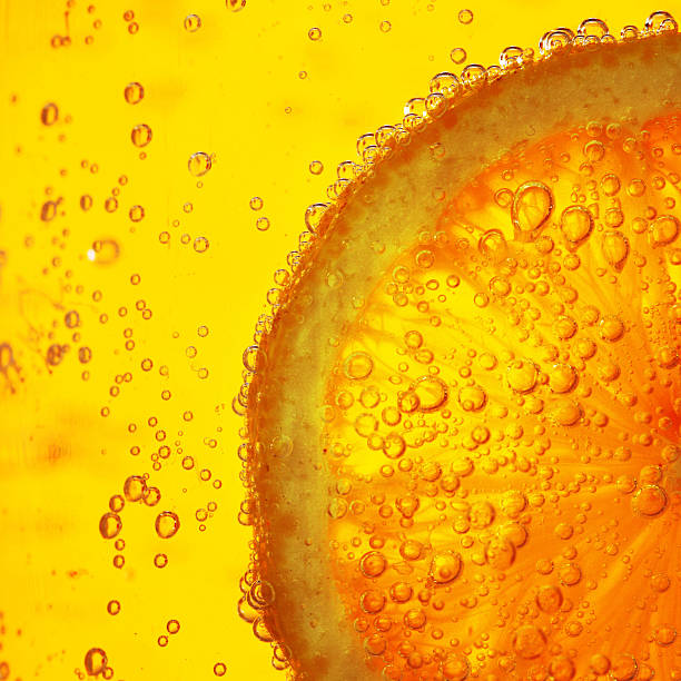 porción en agua de limón - splashing orange fruit water fotografías e imágenes de stock