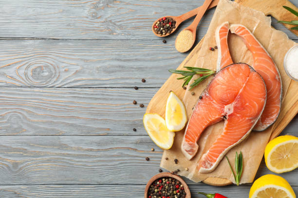 istock Composition with salmon meat and spices on wooden background, top view 1245897136