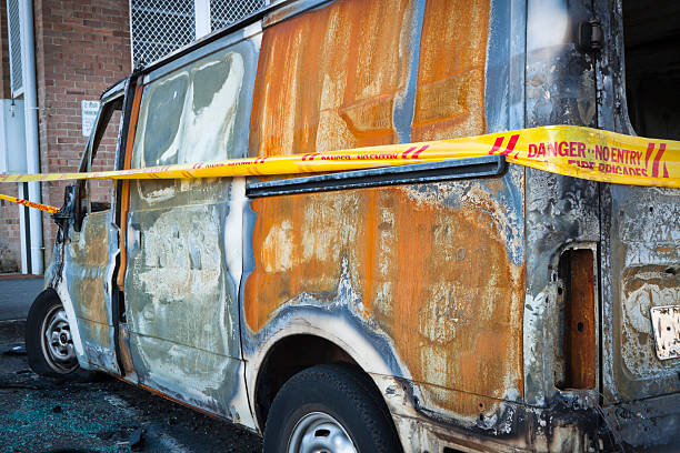 istock Burnt down van with trespassing cordon tape - vandalism 124589780