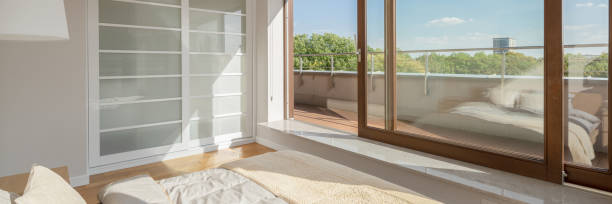 istock Bedroom with window wall and balcony, panorama 1245898736