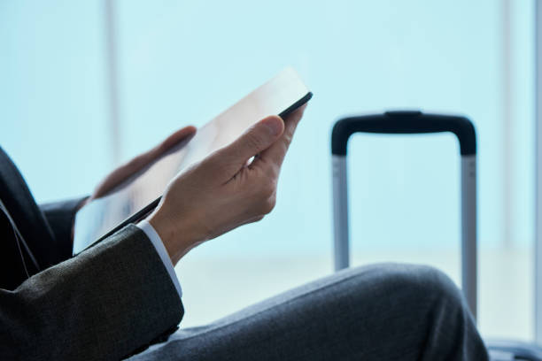 istock businessman using his tablet at the airport 1245909112