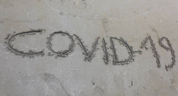 istock Text Covid-19 on the sand of the beach 1245909127