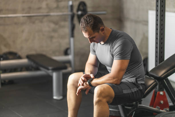 istock Sports man setting his smart watch before training in gym 1245909272