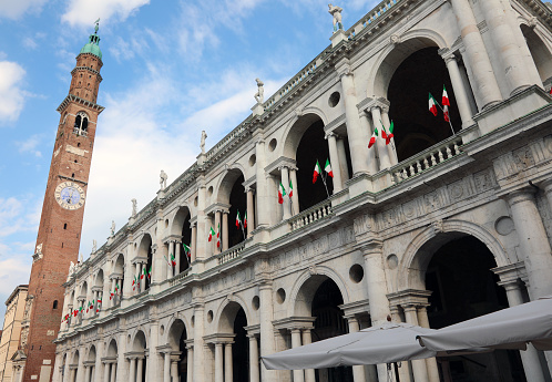 high Tower called Torre Bissara in Vicenza City in Northern Italy and many italian flags