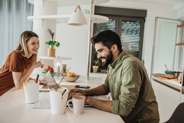 istock A young couple working from home on their laptops 1245909580
