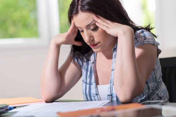 istock Desperate businesswoman with head in hands 1245910381
