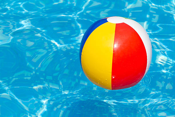 istock Colorful beach ball floating in a swimming pool 124592431