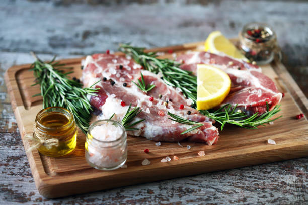 istock Raw meat steaks with lemon and rosemary. 1245924344