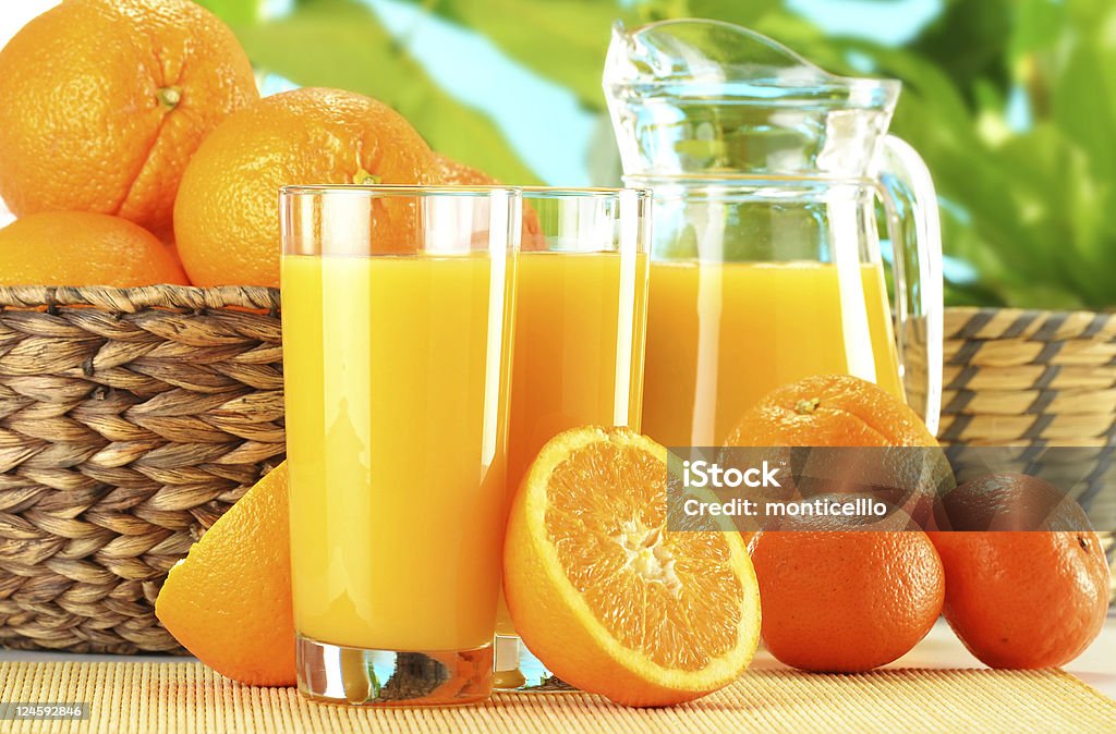 Composition with two glasses of orange juice and fruits Basket Stock Photo