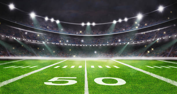 green field in american football stadium. ready for game in the midfield green field in american football stadium. ready for game in the midfield match lighting equipment photos stock pictures, royalty-free photos & images