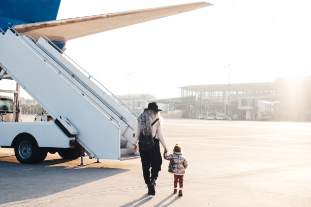 happy single mother and son boarding in airplane - entering airplane imagens e fotografias de stock