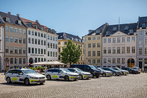 Nytorv, Copenhagen, Denmark, May 29, 2020: Row of police cars in a city square outside a courthouse