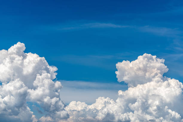 White fluffy clouds on blue sky. Soft touch feeling like cotton. White puffy clouds cape with space for text. Beauty in nature. Close-up white cumulus clouds texture background. Sky on sunny day.