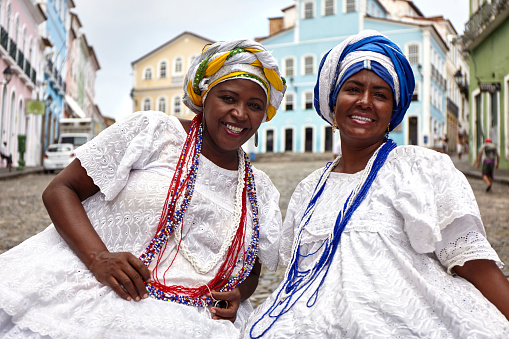Two brazilian women of African descent wearing traditional Baiana costume in the historic Center of Salvador, Bahia, Brazil.