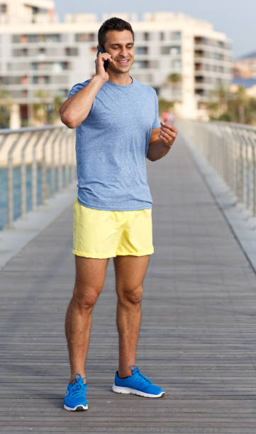 istock Athletic man talking by phone 1245946578