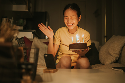 Thai young woman celebrating her birthday without family at her apartment, Bangkok Thailand