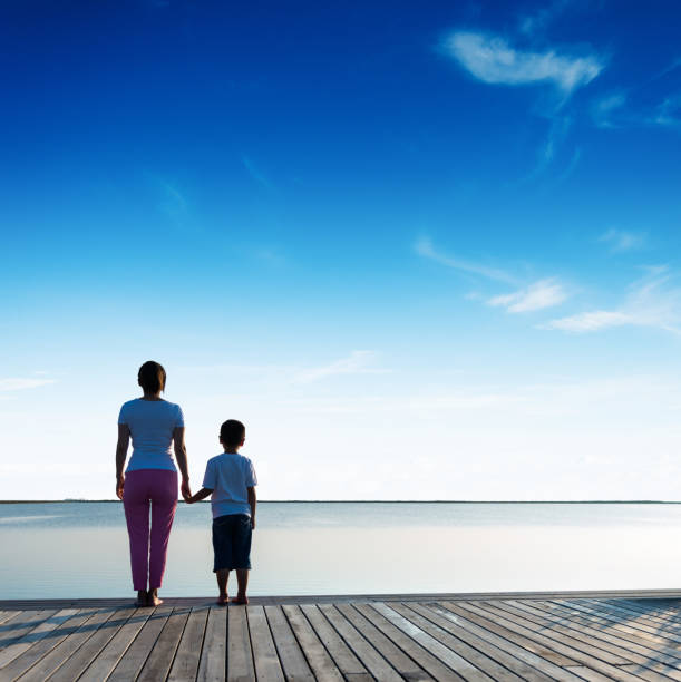 istock Mother with her son enjoying lake view 1245967404