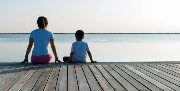 istock Mother with her son enjoying lake view 1245967924