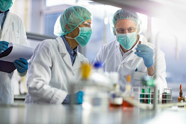 istock Chemists cooperating while analyzing chemical substance in laboratory. 1245973658