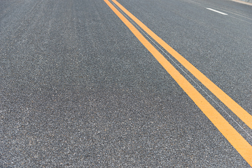 Damaged asphalt pavement , close up of a damaged and defective road