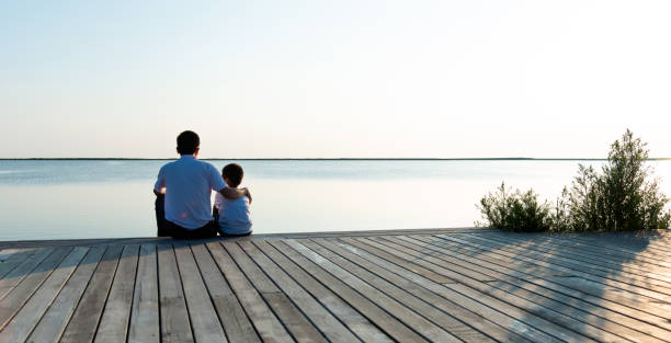 istock Father with his son enjoying lake view 1245984791
