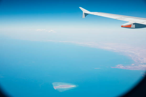 Looking out and down onto the beautiful view while flying on an aeroplane.